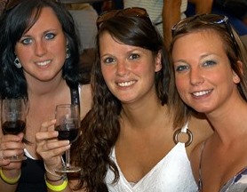 Three women tasting wine at festival
